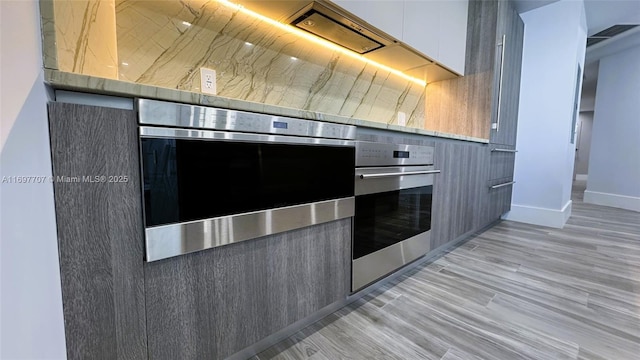 801 S Miami Ave Unit 3205/04, Miami, FL 33130 - kitchen featuring modern cabinets, light wood-type flooring, visible vents, white cabinets, and oven