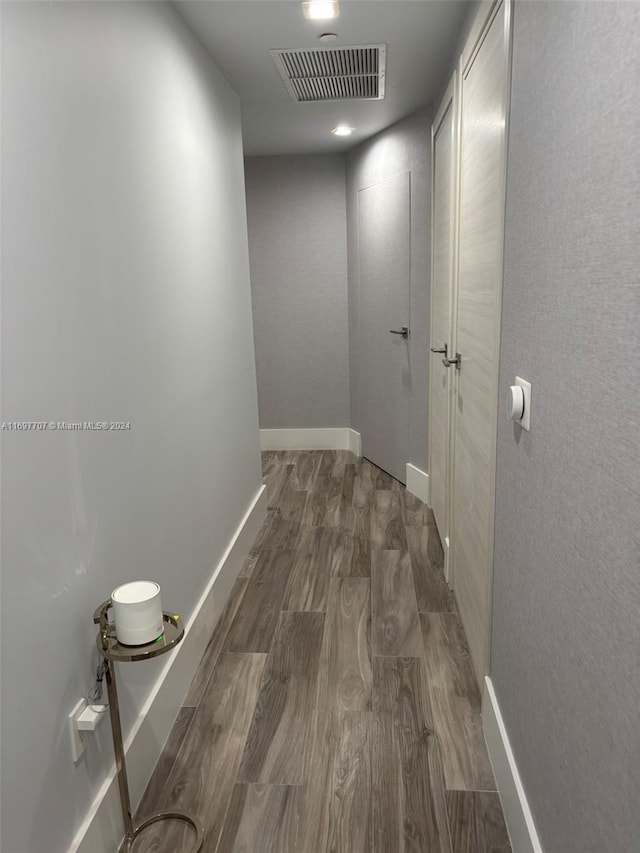 corridor with dark hardwood / wood-style flooring