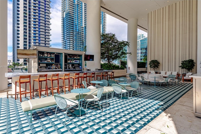 view of patio with an outdoor living space and a bar