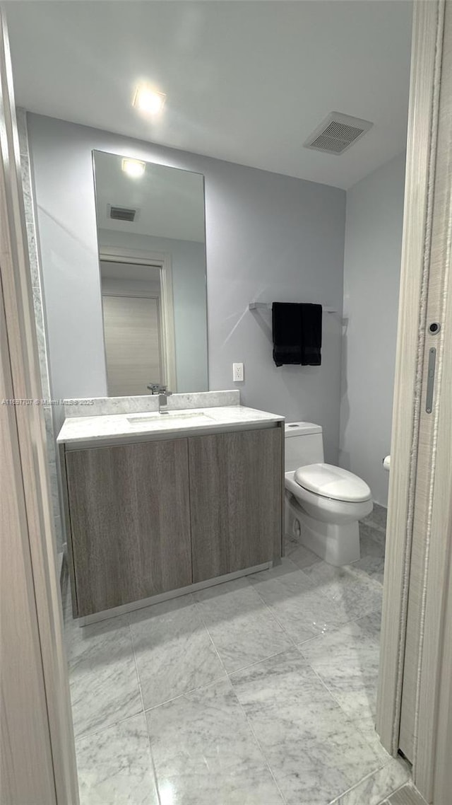 801 S Miami Ave Unit 3205/04, Miami, FL 33130 - half bathroom with marble finish floor, visible vents, toilet, and vanity