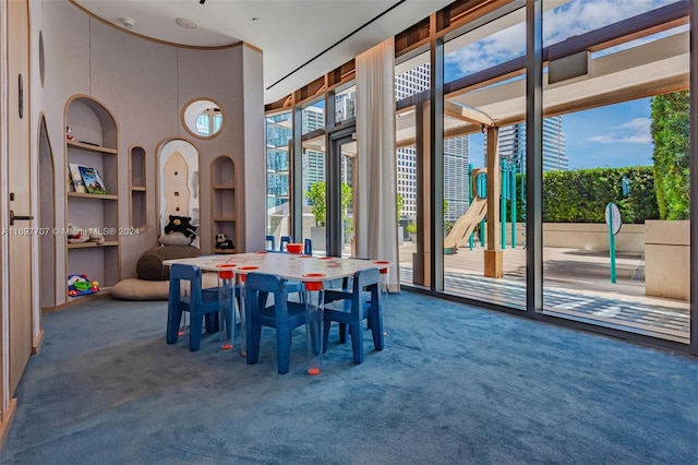 carpeted dining area featuring built in features