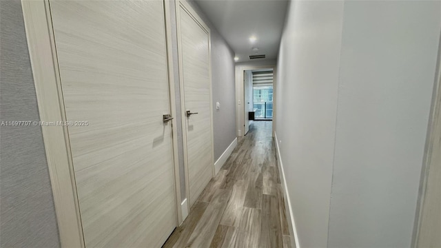 801 S Miami Ave Unit 3205/04, Miami, FL 33130 - hall featuring visible vents, baseboards, and wood finished floors