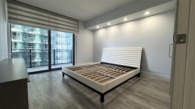 801 S Miami Ave Unit 3205/04, Miami, FL 33130 - bedroom featuring recessed lighting, baseboards, a wall of windows, and wood finished floors