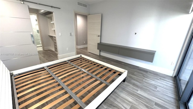 801 S Miami Ave Unit 3205/04, Miami, FL 33130 - unfurnished bedroom featuring baseboards, visible vents, and wood finished floors