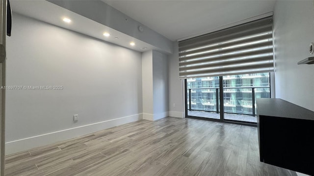 801 S Miami Ave Unit 3205/04, Miami, FL 33130 - empty room with baseboards, wood finished floors, recessed lighting, and a wall of windows