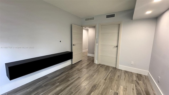 801 S Miami Ave Unit 3205/04, Miami, FL 33130 - unfurnished bedroom with baseboards, visible vents, a closet, and wood finished floors