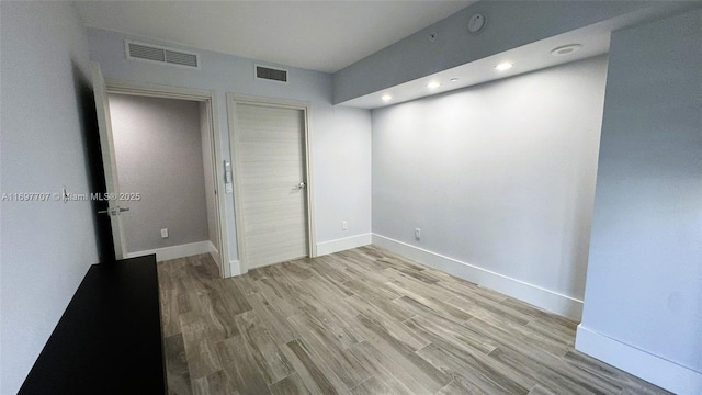 801 S Miami Ave Unit 3205/04, Miami, FL 33130 - unfurnished bedroom featuring baseboards, visible vents, a closet, and light wood-type flooring