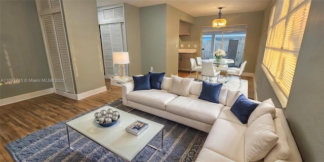 living area featuring dark wood-style floors and baseboards