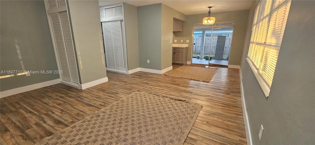 foyer entrance featuring wood finished floors and baseboards