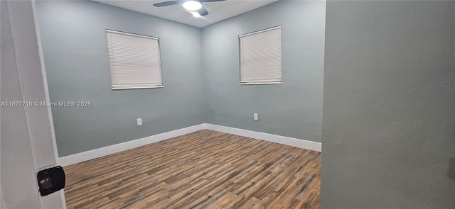 unfurnished room with a ceiling fan, baseboards, and wood finished floors