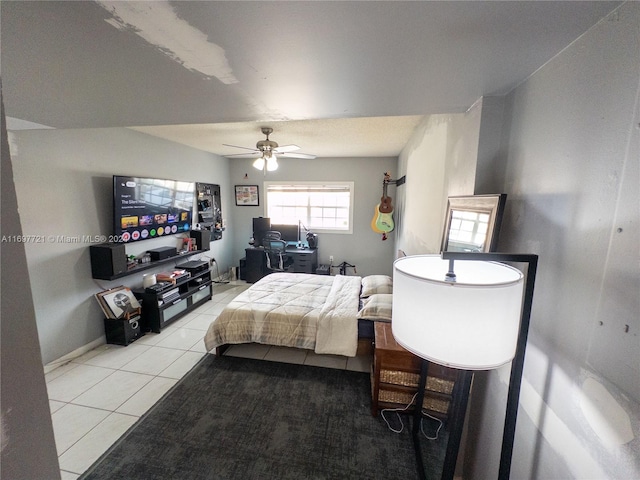 bedroom with ceiling fan and light tile patterned floors