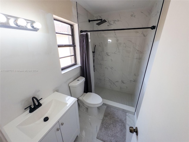 bathroom featuring curtained shower, vanity, and toilet