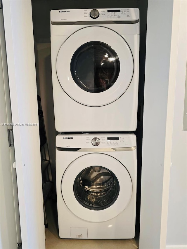 washroom featuring stacked washer / drying machine