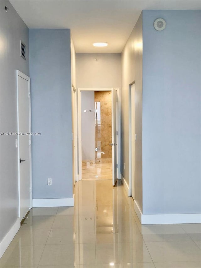 corridor featuring light tile patterned floors