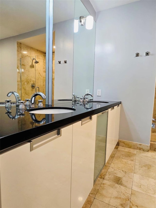 bathroom with vanity and a shower with shower door