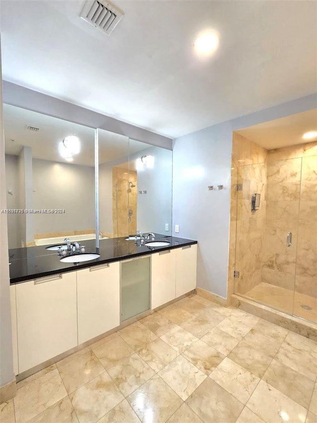 bathroom with vanity and a shower with shower door