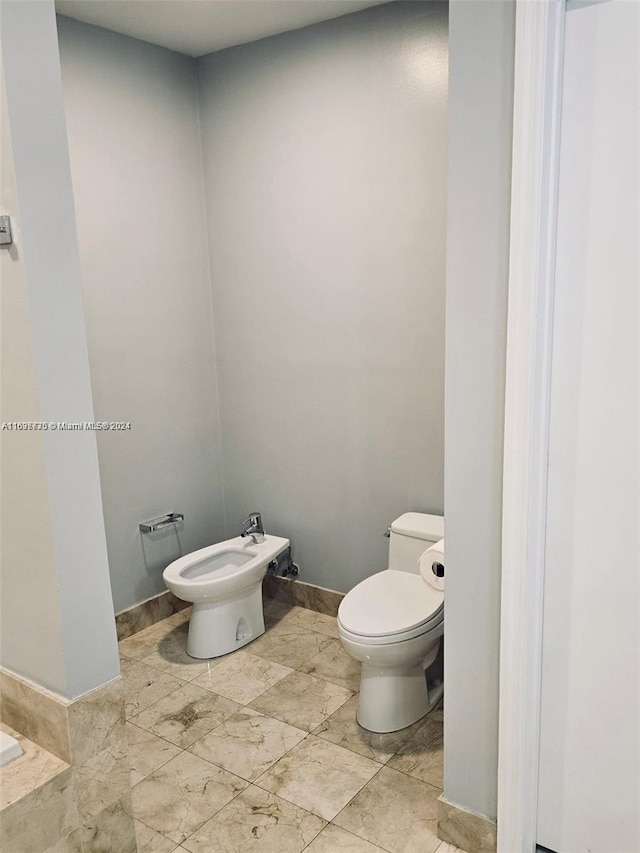 bathroom featuring a bidet and toilet