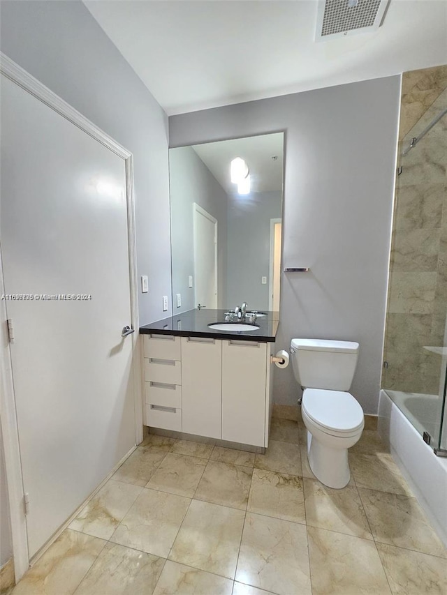 full bathroom featuring toilet, vanity, and tiled shower / bath