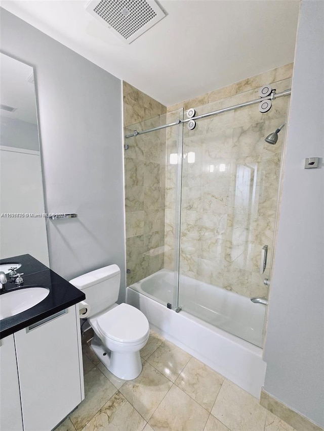 full bathroom featuring toilet, vanity, and tiled shower / bath