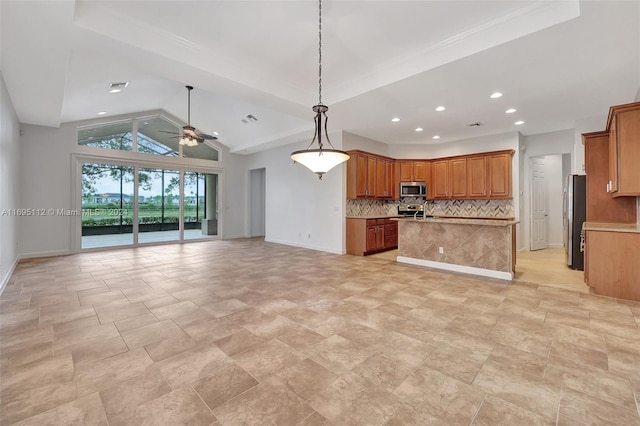 kitchen with appliances with stainless steel finishes, tasteful backsplash, ceiling fan, pendant lighting, and lofted ceiling