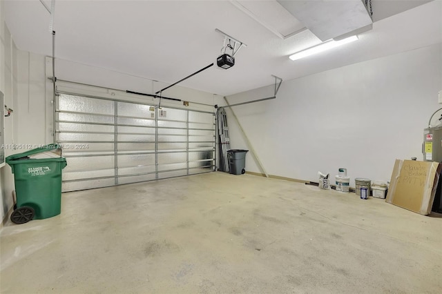 garage featuring electric water heater and a garage door opener