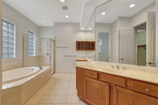 bathroom with tile patterned flooring, vanity, and shower with separate bathtub