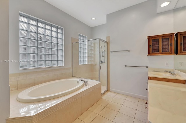 bathroom with tile patterned floors, vanity, and separate shower and tub