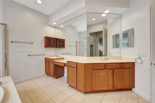 bathroom featuring tile patterned flooring, vanity, and separate shower and tub