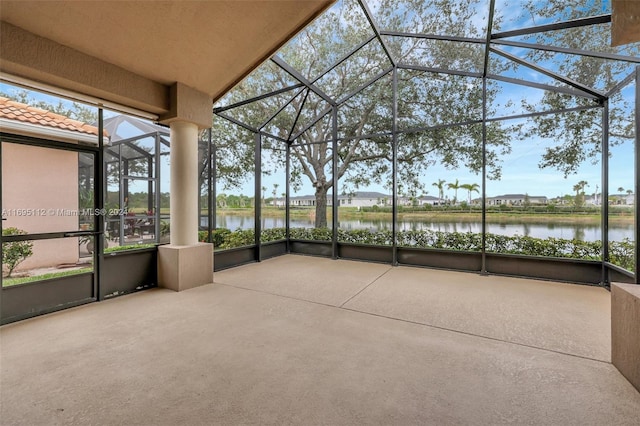 unfurnished sunroom featuring a water view and lofted ceiling