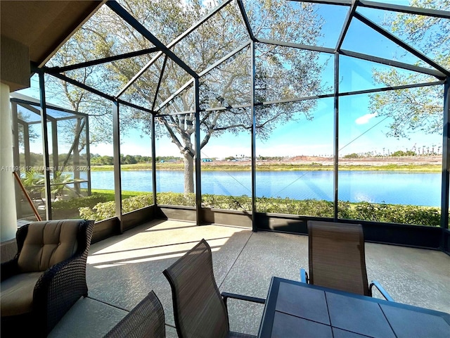 view of patio / terrace with a lanai and a water view