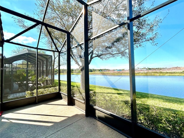 unfurnished sunroom with a water view