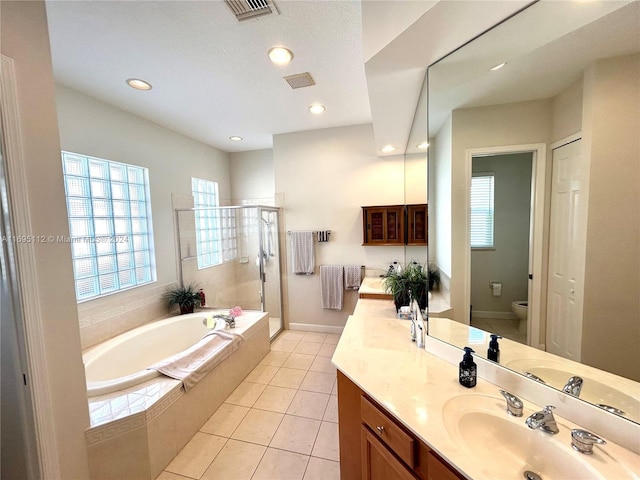 full bathroom with separate shower and tub, tile patterned floors, vanity, and toilet