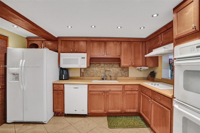 kitchen with decorative backsplash, sink, light tile patterned floors, and white appliances