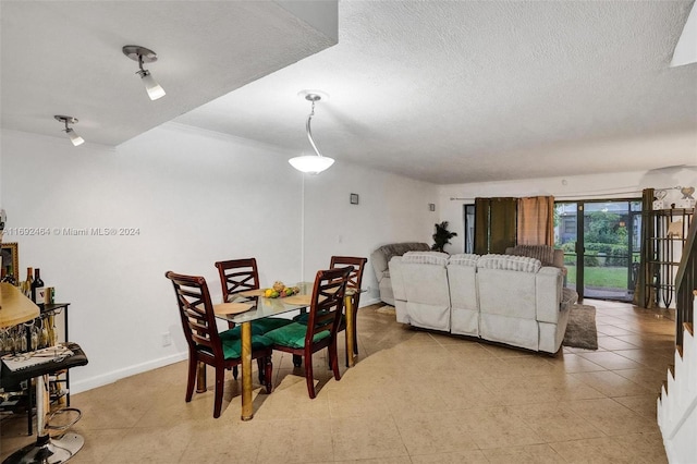 dining area with crown molding and a textured ceiling