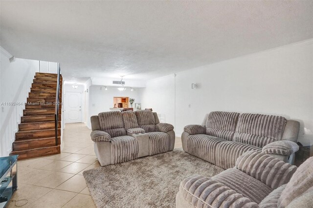 living room with light tile patterned floors and a textured ceiling