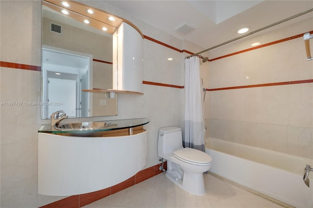 full bathroom with vanity, tile patterned floors, toilet, shower / bathtub combination with curtain, and tile walls