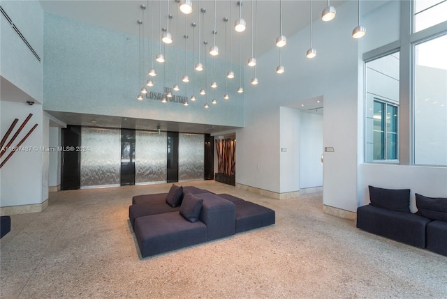 living room with a towering ceiling