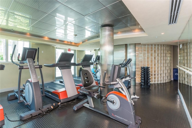 exercise room featuring a tray ceiling