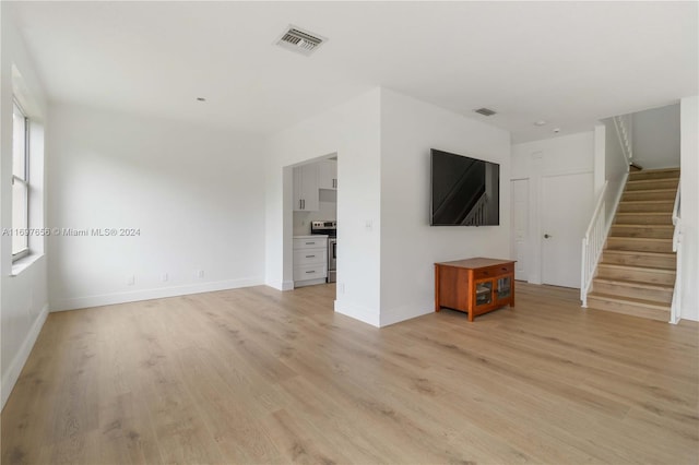 unfurnished living room with light hardwood / wood-style flooring