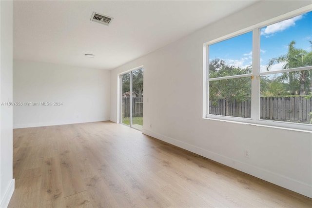 empty room with plenty of natural light and light wood-type flooring