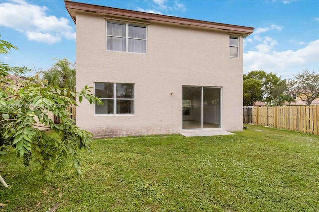 rear view of house featuring a lawn