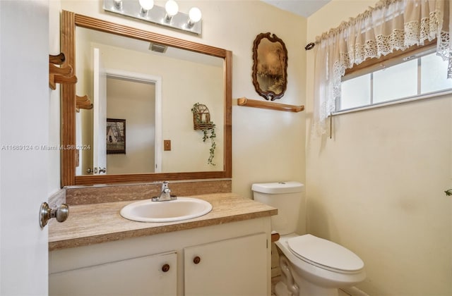 bathroom featuring vanity and toilet