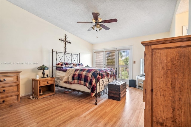 bedroom featuring access to exterior, a textured ceiling, light hardwood / wood-style floors, and ceiling fan