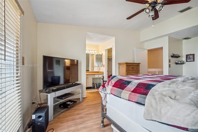 bedroom featuring ensuite bath, ceiling fan, and light hardwood / wood-style flooring