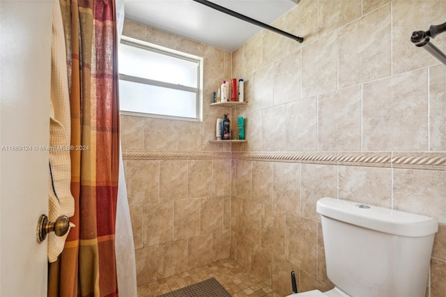 bathroom featuring toilet, tile walls, and walk in shower