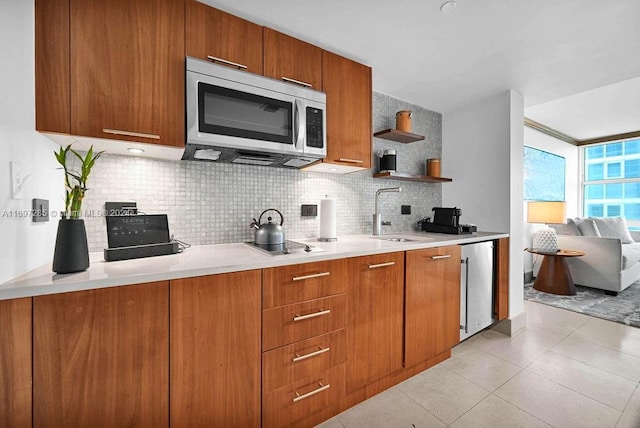 kitchen featuring sink, light tile patterned floors, stainless steel appliances, and tasteful backsplash