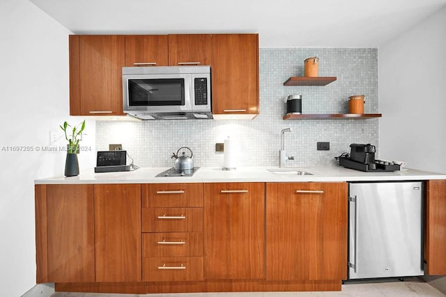 kitchen with decorative backsplash, stainless steel appliances, and sink