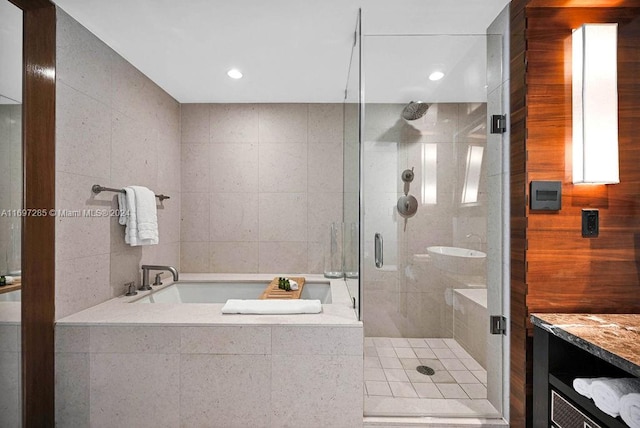 bathroom with vanity, tile walls, and independent shower and bath