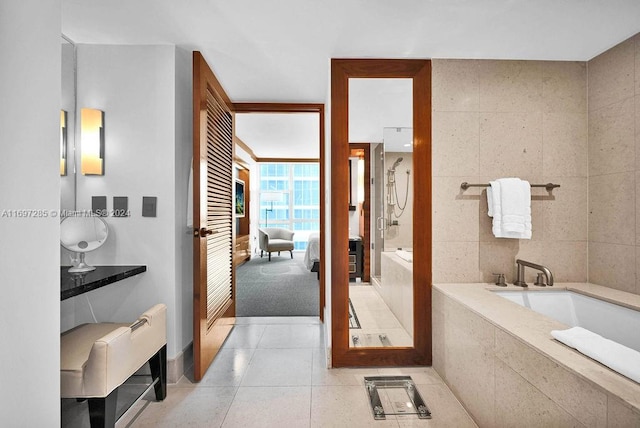 bathroom featuring tile patterned flooring, shower with separate bathtub, and tile walls