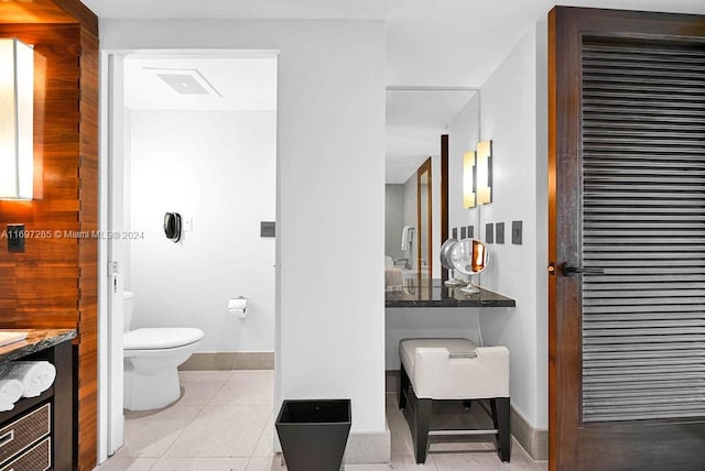 bathroom featuring tile patterned flooring, vanity, and toilet